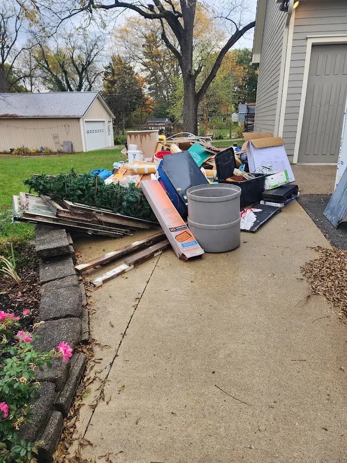 Dumpster being loaded with debris for 12 Yard Dumpster Rental in Plumas Lake